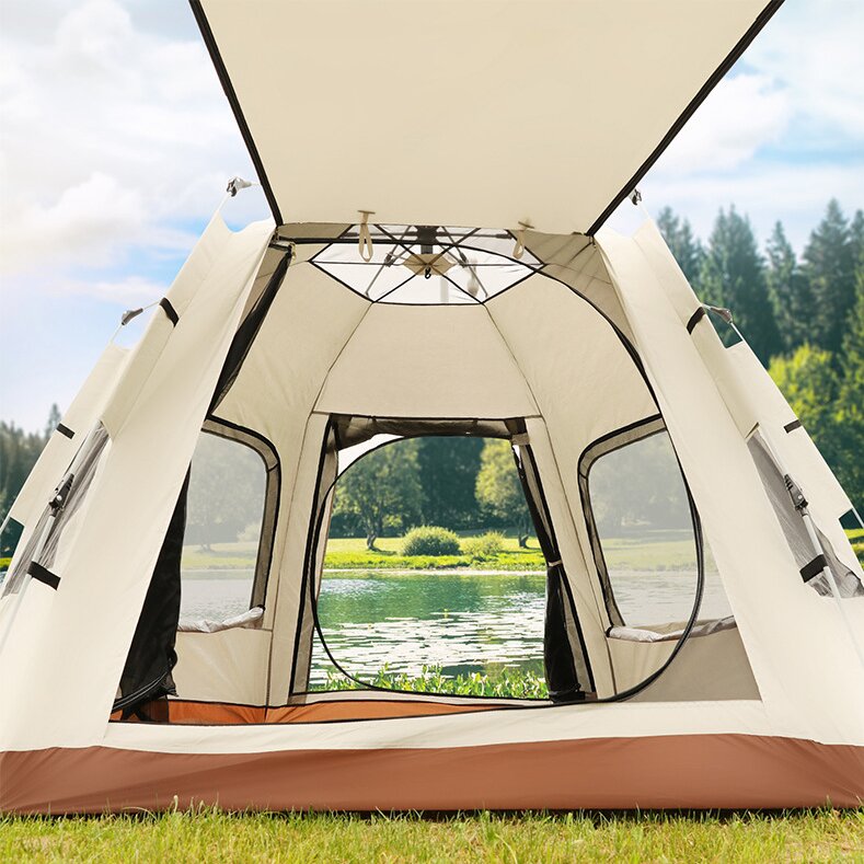 Open camping tent with a view of a lake and trees