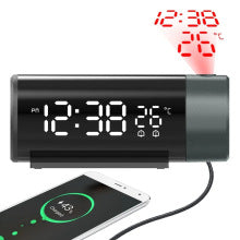 Digital clock with temperature display and wireless charging pad on a white background