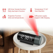 Digital clock with red light projection on a wooden floor
