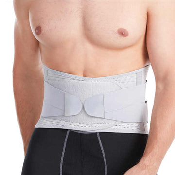 Man wearing a gray waist support belt on a white background