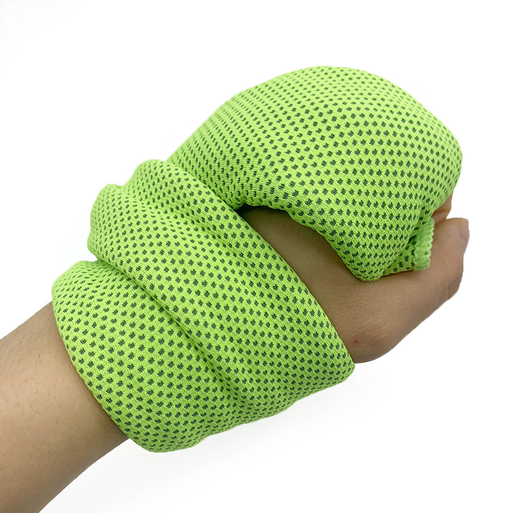 Hand wearing a bright green textured wristband on a white background