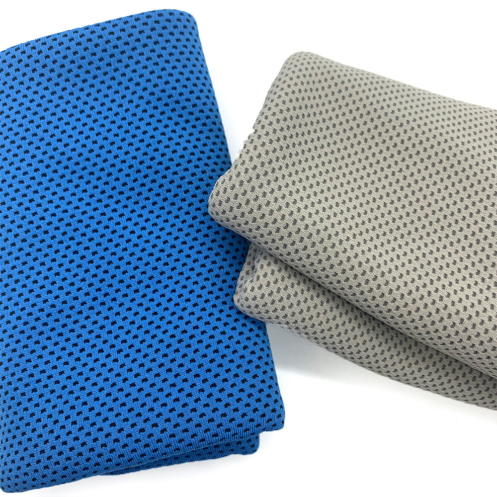 Two folded towels, one blue and one gray, on a white background