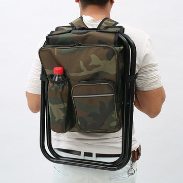 Person wearing a camouflage backpack with a chair attached on a white background