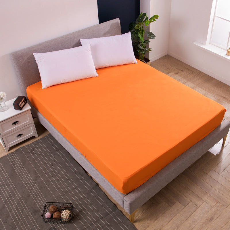 Orange bed sheet on a bed in a bedroom setting