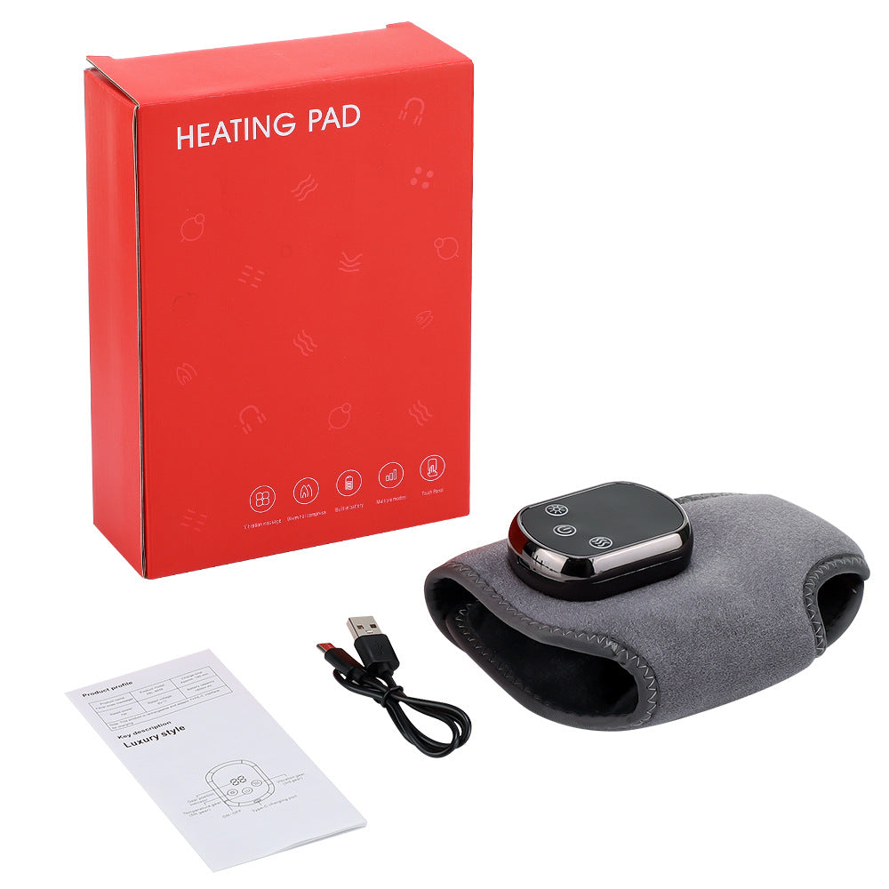 Heating pad with red packaging, USB cable, and user manual on a white background
