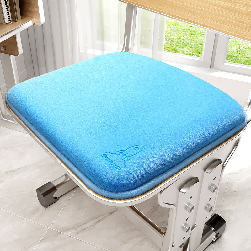 Blue cushion on a chair with a window in the background