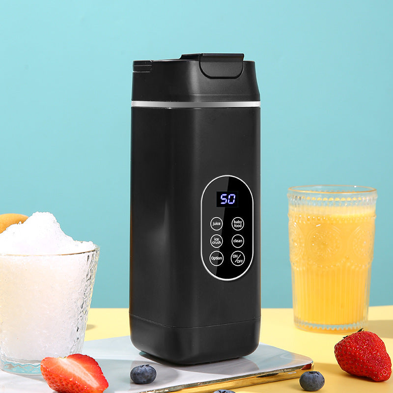 Black travel mug with digital display on a table with ingredients and a glass of juice.