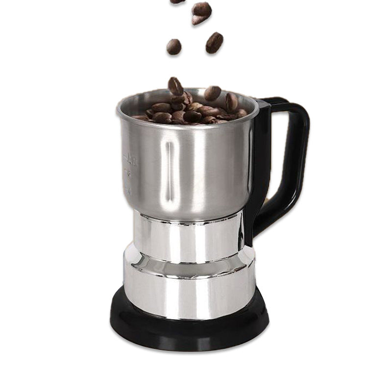 Stainless steel coffee maker with black handle and base, filled with coffee beans on a white background
