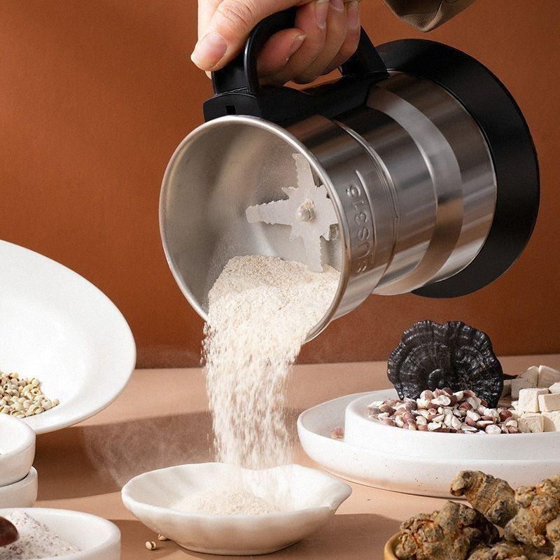 Person pouring a powdery substance from a metal measuring cup into a bowl.
