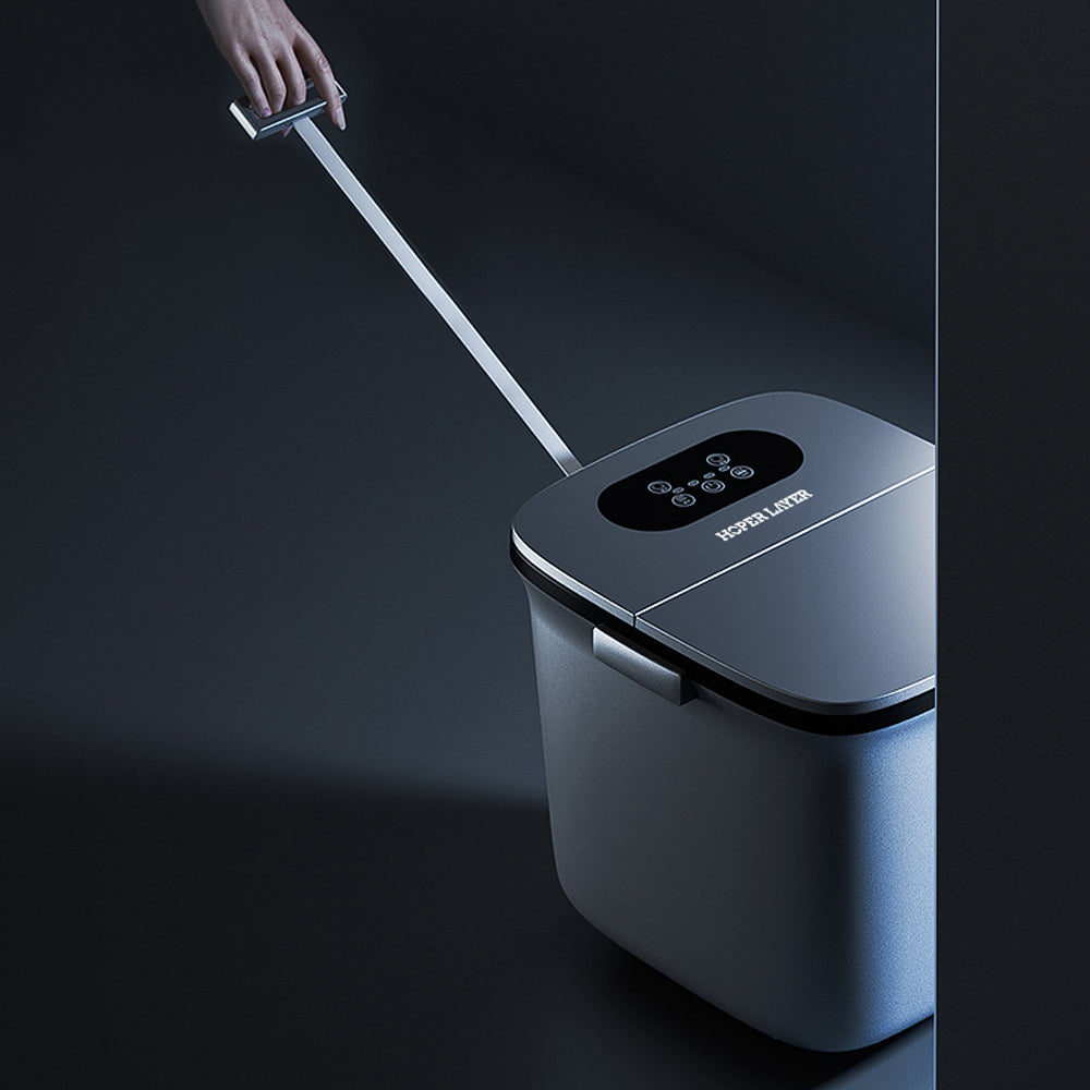 Hand pulling a handle on a modern trash can against a dark background