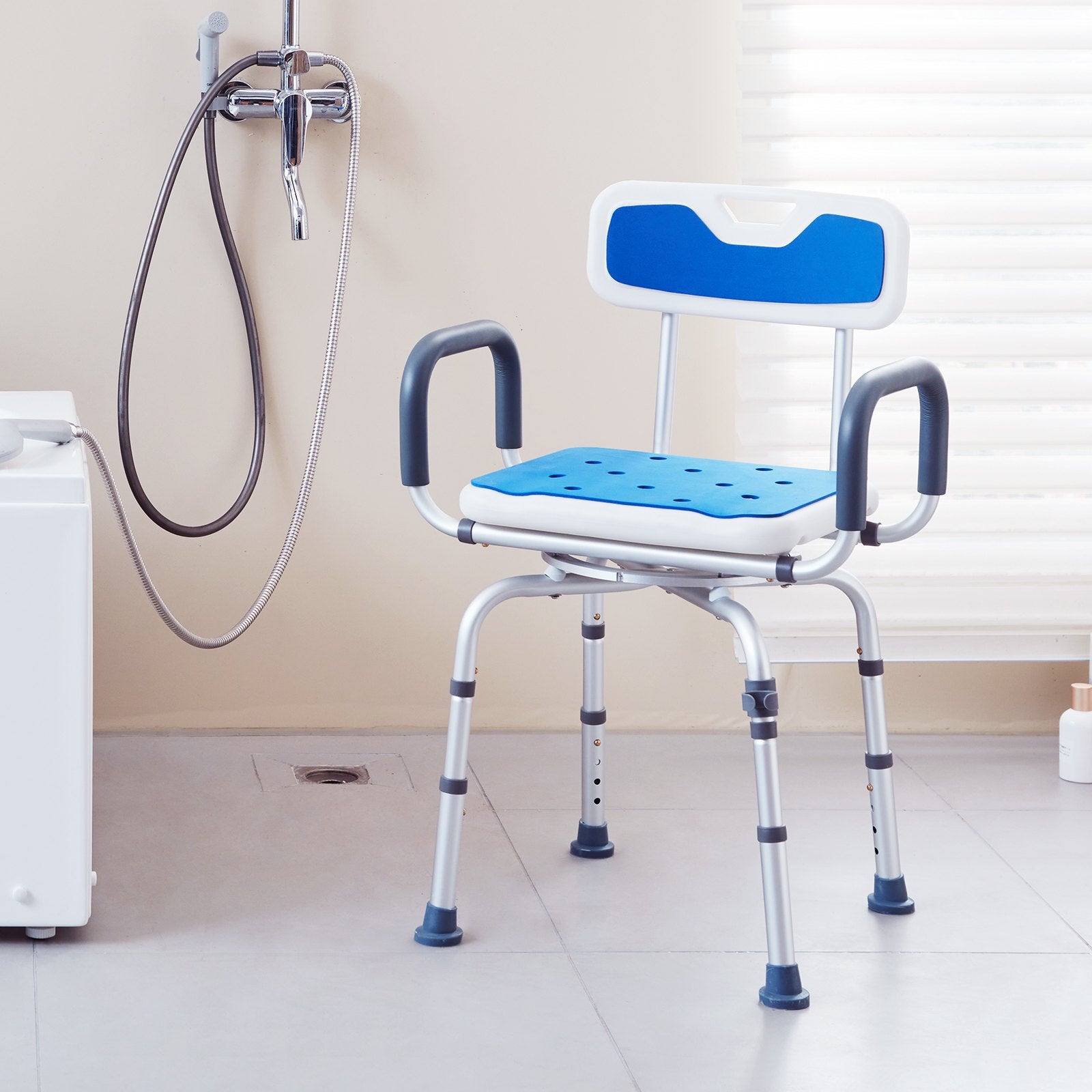 Blue and white shower chair in a bathroom setting with a shower head and hose.