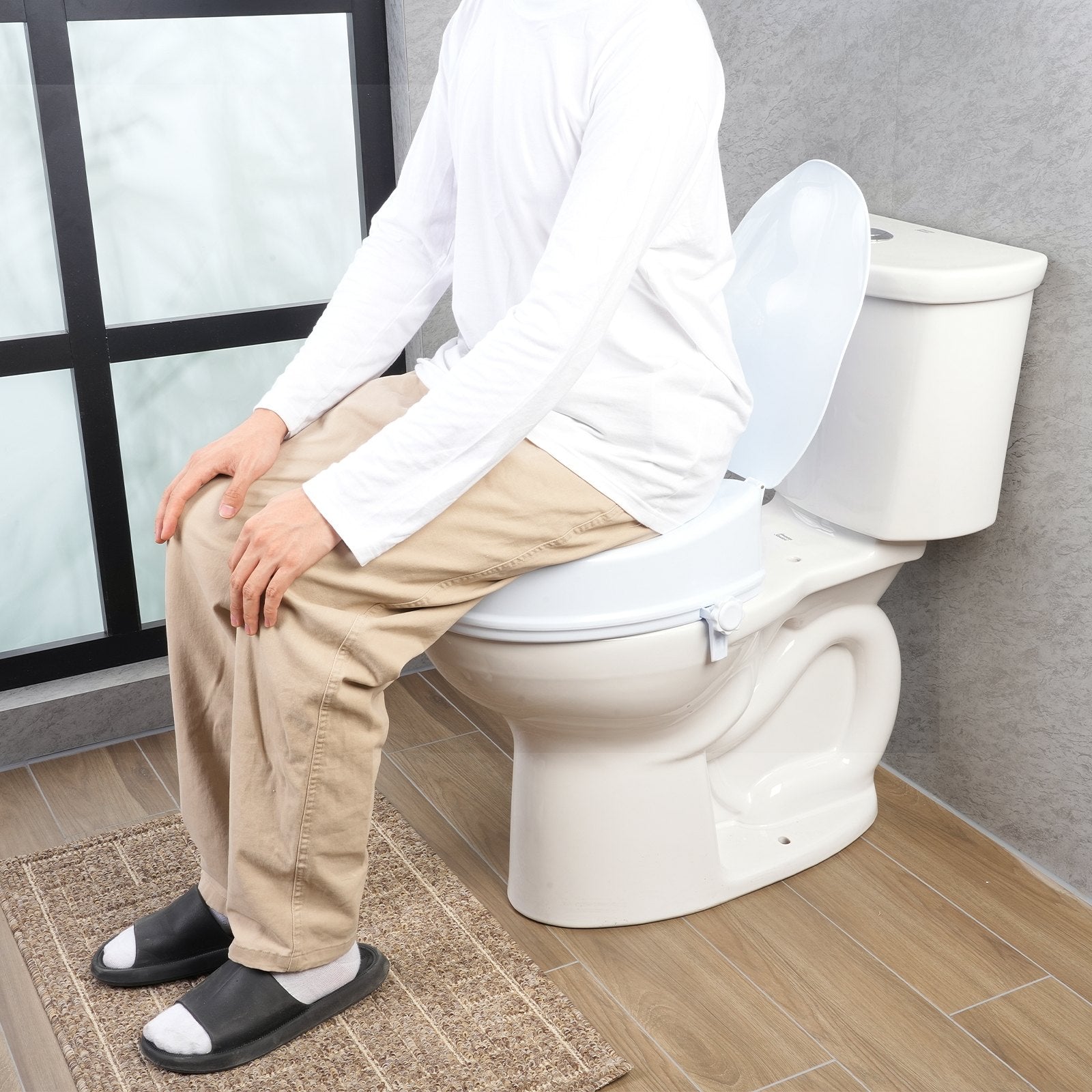 Person sitting on a toilet with a seat cover in a bathroom setting