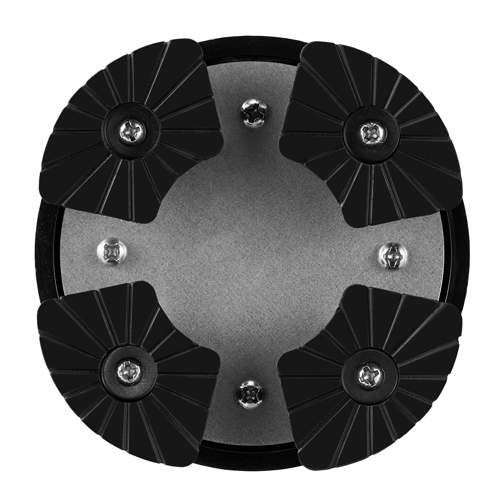 Top view of a circular metal object with black rubber pads on a white background