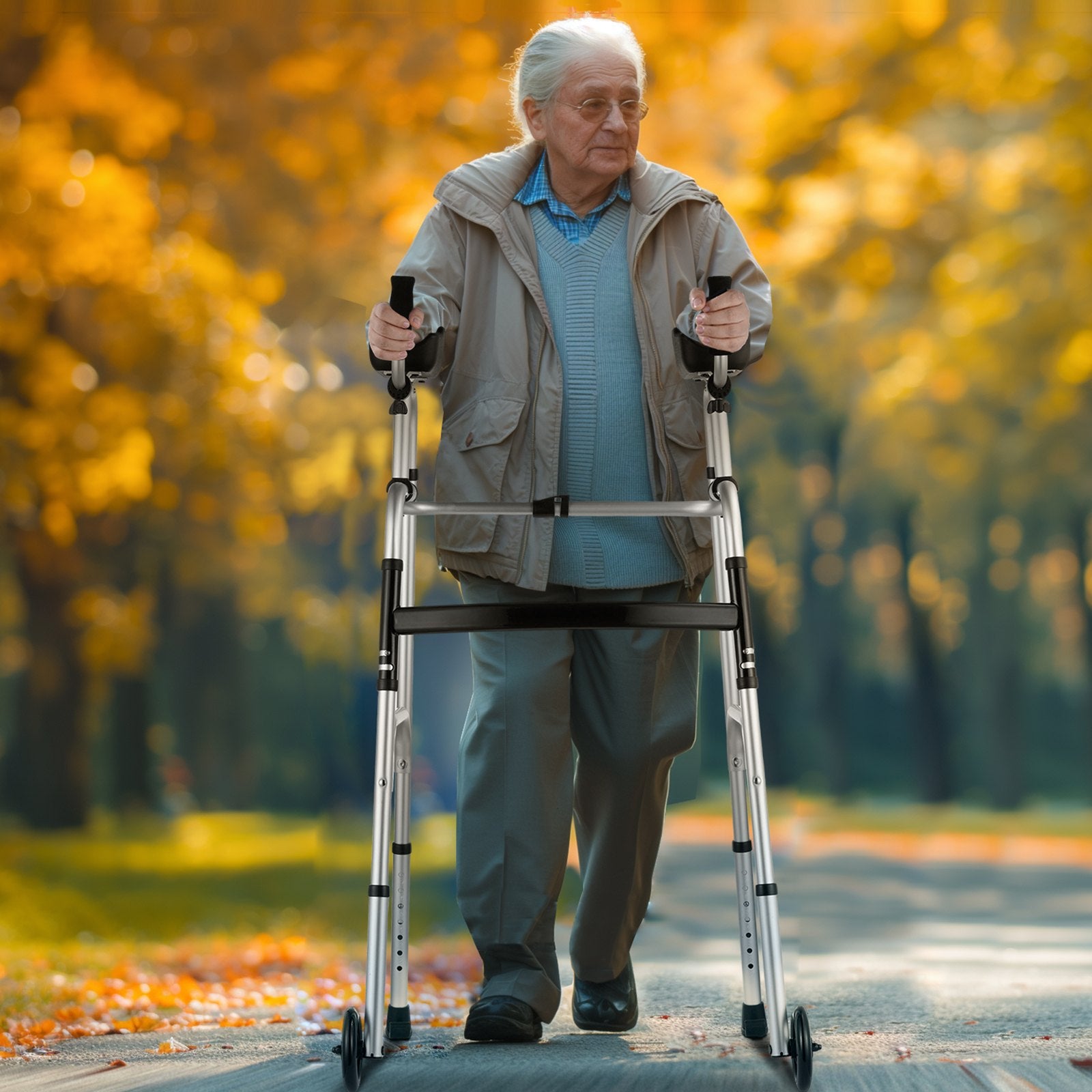 Senior man using a walker in an autumn park