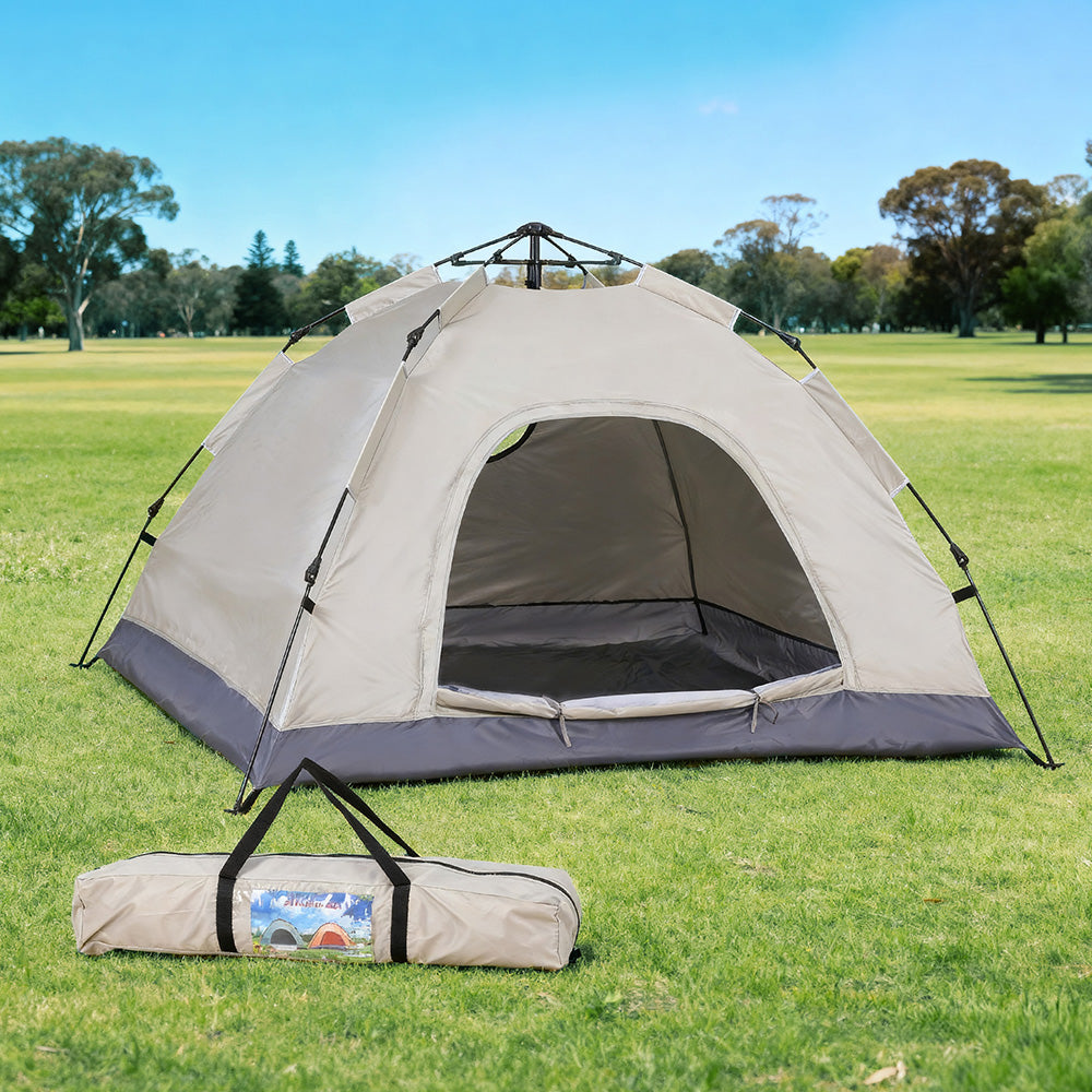 Camping tent with carrying bag on grassy field